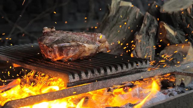 Beef steak is cooked on grill with sparks. Beef Rib BBQ