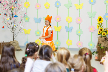 young actress in a fox costume speaking in front of children