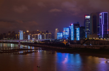 Fototapeta na wymiar Chungking reflected in calm Jialing river in China 