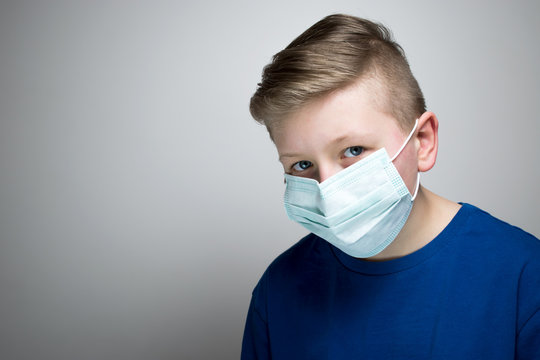 A Child In An Antiviral Mask. The Boy Put On An Antiviral Mask.