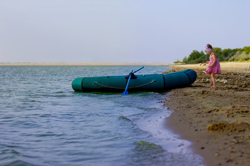  Little girl with a boat on the lake, summer, vacation, travel.