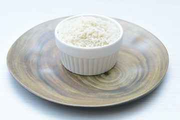 Natural raw white rice grains, on display in bowl