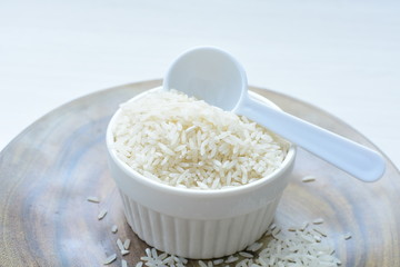 Natural raw white rice grains, on display in bowl