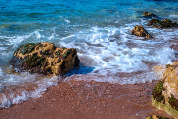 small waves on the shore with stones, Athens, Greece