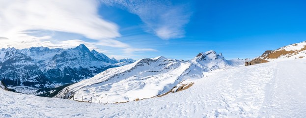 Wide parnoramic view of snow covered Swiss Alps from Mannlichen mountain in Grindelwald ski resort, Switzerland