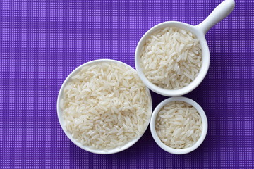 Natural raw white rice grains, on display in bowl