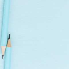 Pastel colored pencils on empty sheet, blue toned