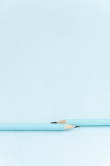 Pastel colored pencils on empty sheet, blue toned