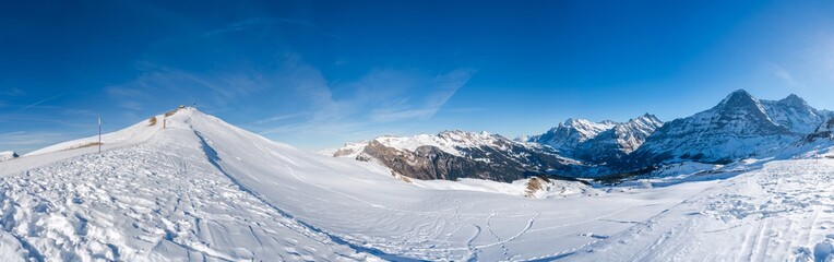 Wide parnoramic view of Swiss Alps in the winter at Mannlichen summit, Grindelwald, Switzerland