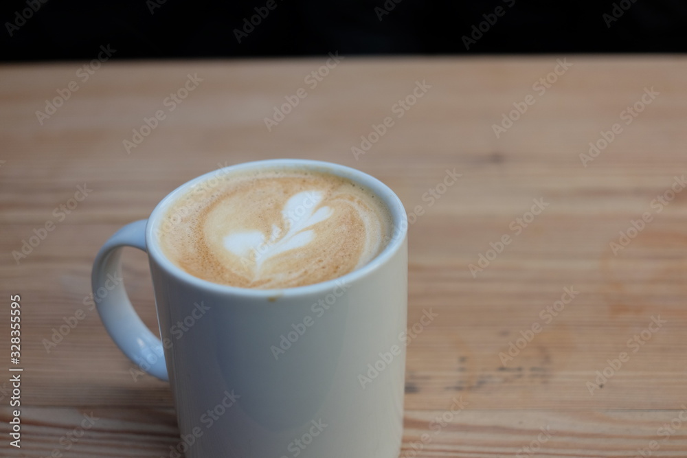 Wall mural cup of coffee on wooden table