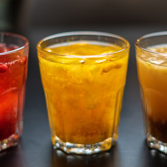 Berry and fruit drinks in glasses close-up.