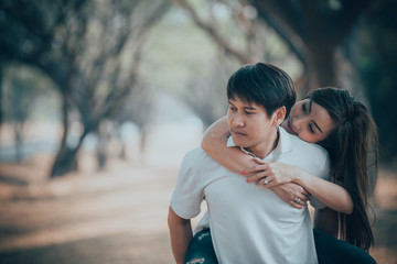 Portrait of young asian couple in love  in the forest,Thailand people happy to be together,Valentine day concept