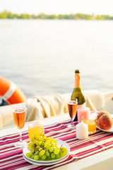 Romantic breakfast or dinner on a motor yacht. Hard sunlight.
