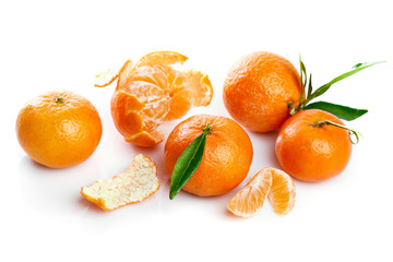 Ripe tangerines with green leaf in cut. Fruity still life citrus. Isolated on white background.