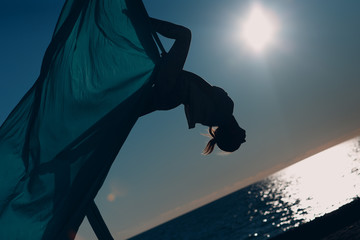 Aerial yoga on the beach. Self care and wellness Woman.