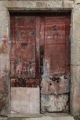 Ruined rotten door. Old and abandoned wooden door