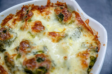 Fresh baked brocolli and cheese. Tasty food, detail, close up. 