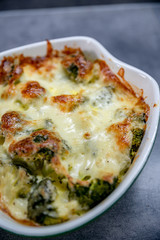 Fresh baked brocolli and cheese. Tasty food, detail, close up. 
