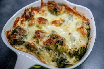 Fresh baked brocolli and cheese. Tasty food, detail, close up. 