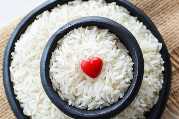 Natural raw white rice grains, on display in bowl