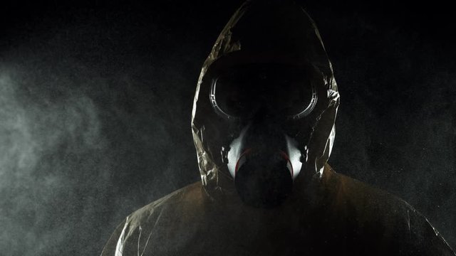 Super slow motion of man in chemical suit with respirator and goggles. Filmed on high speed cinema camera