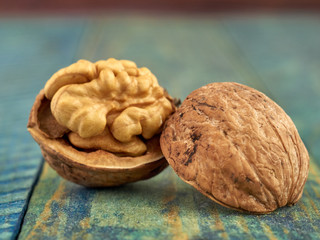 Walnut kernels on a dark table with a colored background