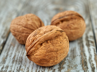 Walnut kernels on a dark table with a colored background