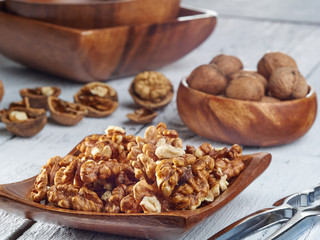 Walnut kernels on a dark table with a colored background