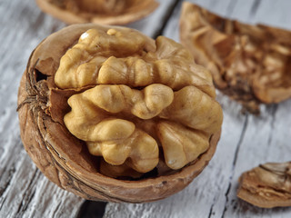 Walnut kernels on a dark table with a colored background