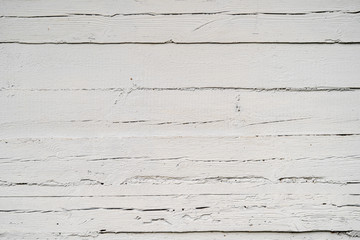 Texture od wooden planks painted with a white paint. Wall made of antique wood after century.