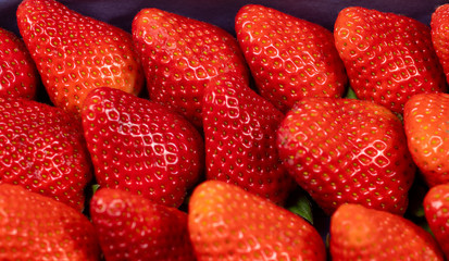 background from freshly harvested strawberries, closeup