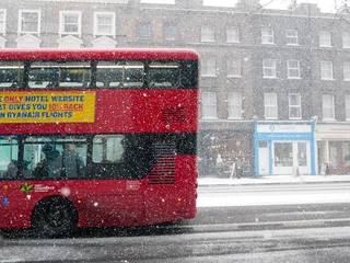 Foto op Plexiglas Rode bus op London Road tijdens sneeuwstorm © toby
