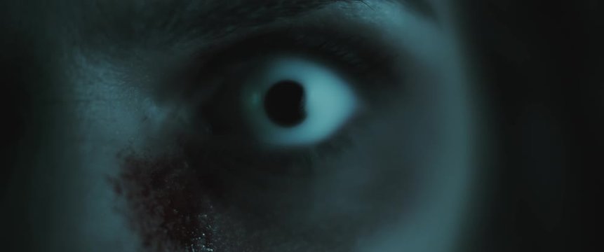 Terrifying creepy zombie woman, close up of white eye. Scary look. BMPCC 4K