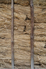 Wall of an ancient country house insulated with straw.