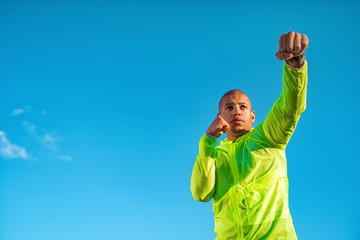 Sporty man doing boxing exercise outdoors. Healthy lifestyle