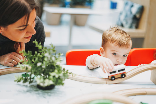 Cute Baby Boy Toddler Child With Mother Play With Car Toys In Game Room In The Shopping Mall