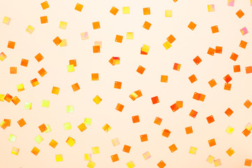 Minimal festive ivory background with shining mosaic confetti. Modern flat lay with space for text.