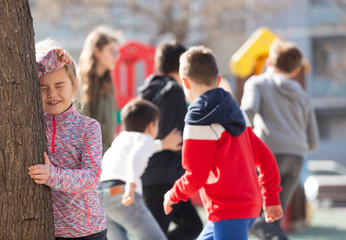 Teenage playing hide-and-go-seek in the playground