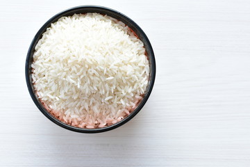 Natural raw white rice grains, on display in bowl