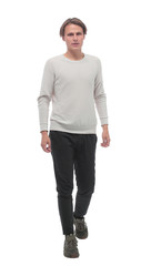 in full growth. confident young man striding forward.