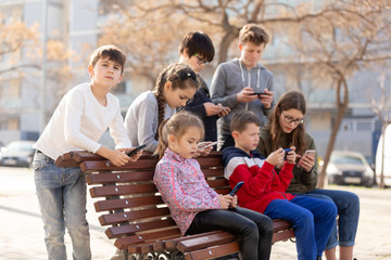 Children addicted in their phones outdoors