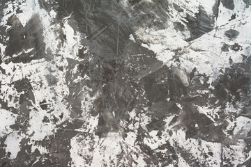 Texture of white putty on a gray surface.