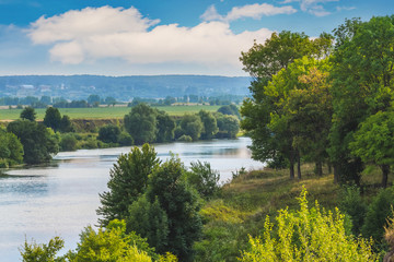 Summer landscape with river and green trees by the river_