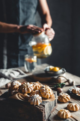 Man pours Hot tea with slices of fresh grapefruit on wooden tablet. Healthy drink, Eco, vegan.