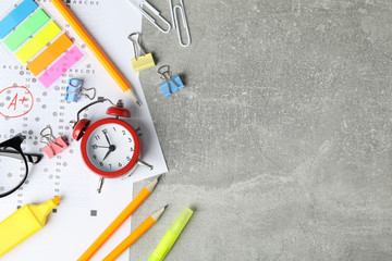 Frame of different stationary on grey background, top view