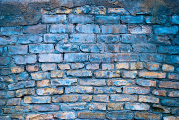 the old yellow-and-blue brick wall and plaster