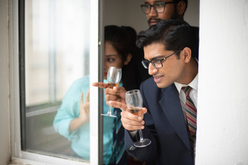 Corporate meetings between  young and energetic Indian Bengali bosses/officers/managers and secretary at window of the office building regarding buying a project land. Indian corporate lifestyle