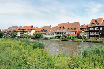 Fototapeta na wymiar View of Little Venice, Residential Houses along Regnitz River Surrounded by Verdant Plants in the City of Bamberg, Germany in June 2016