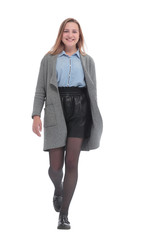 in full growth. fashionable young woman striding forward