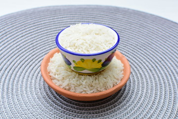 Natural raw white rice grains, on display in bowl